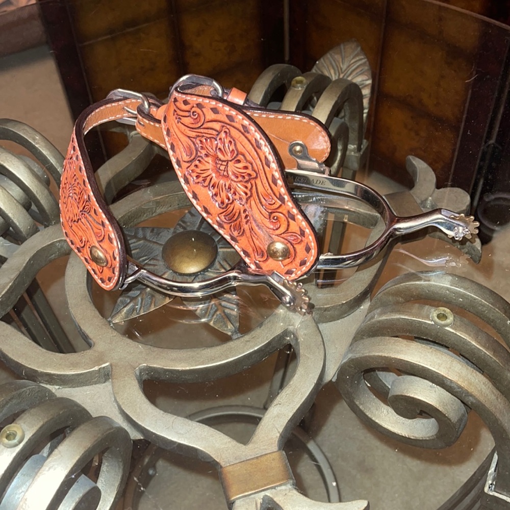 Spurs with leather attachments